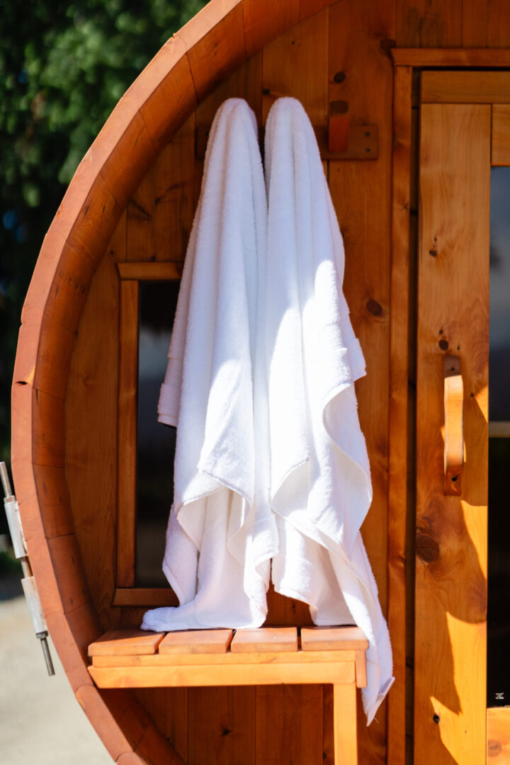 A white towel hanging on the side of a boat.