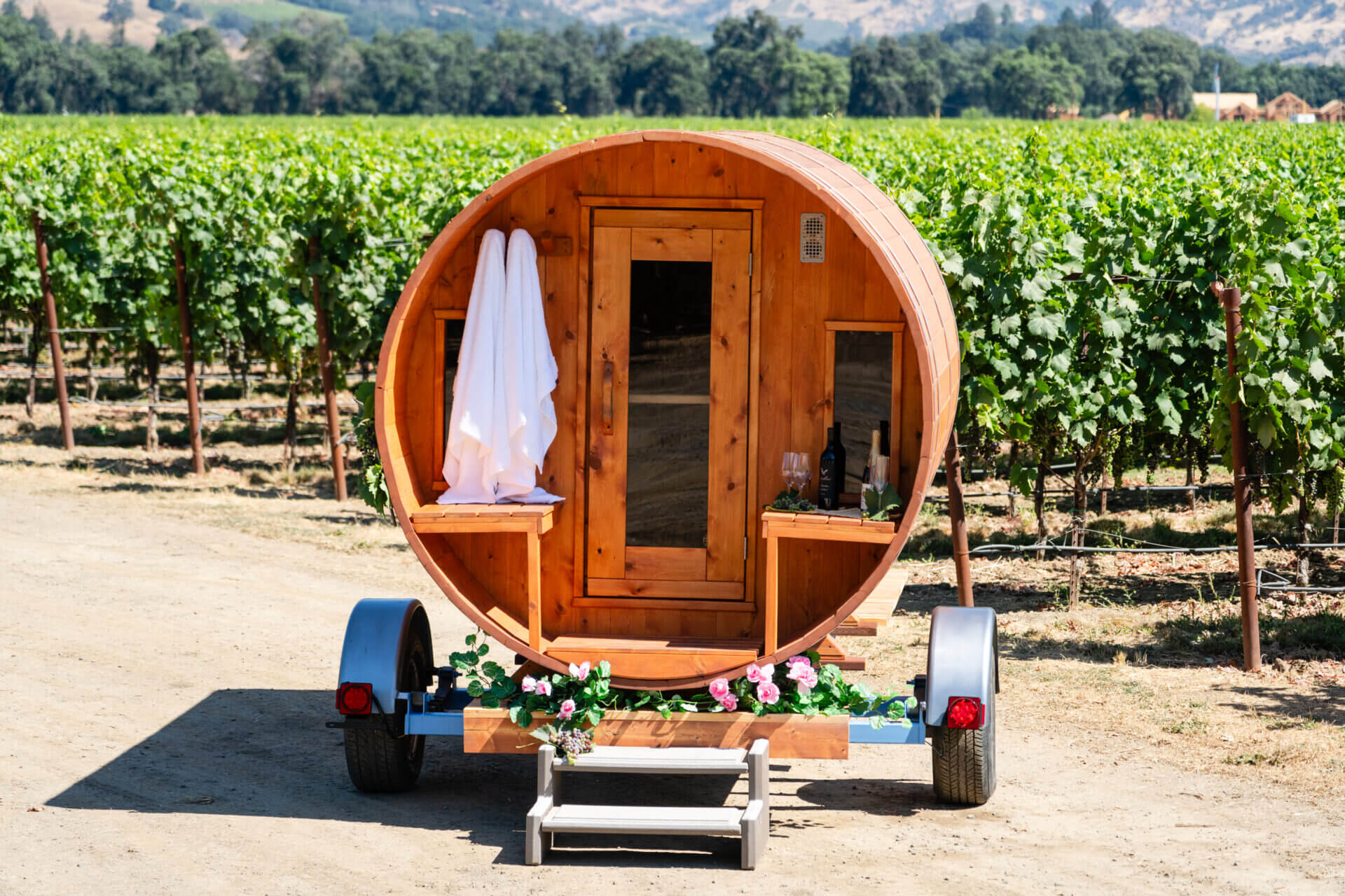 A wooden barrel sitting on top of a trailer.